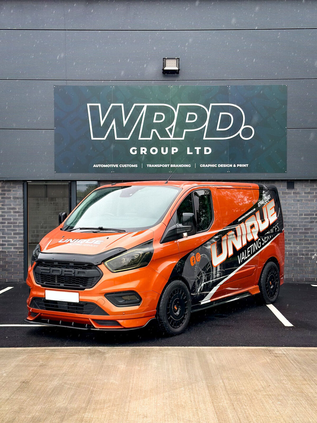 An orange ford transit custom with a V2 Front add on fitted