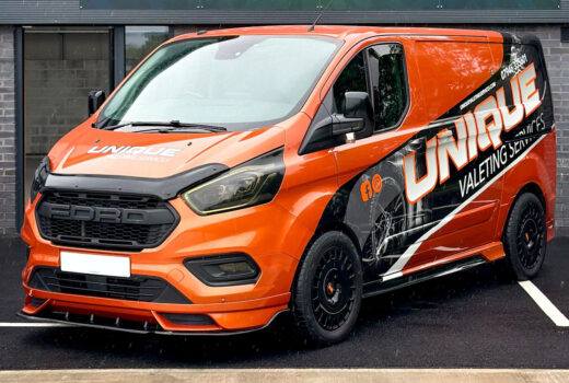 An orange ford transit custom with a V2 Front add on fitted