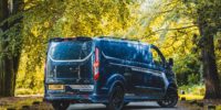 A Ford Transit Custom Roof spoiler in Black sat on a grey Ford Transit Custom Tailgate